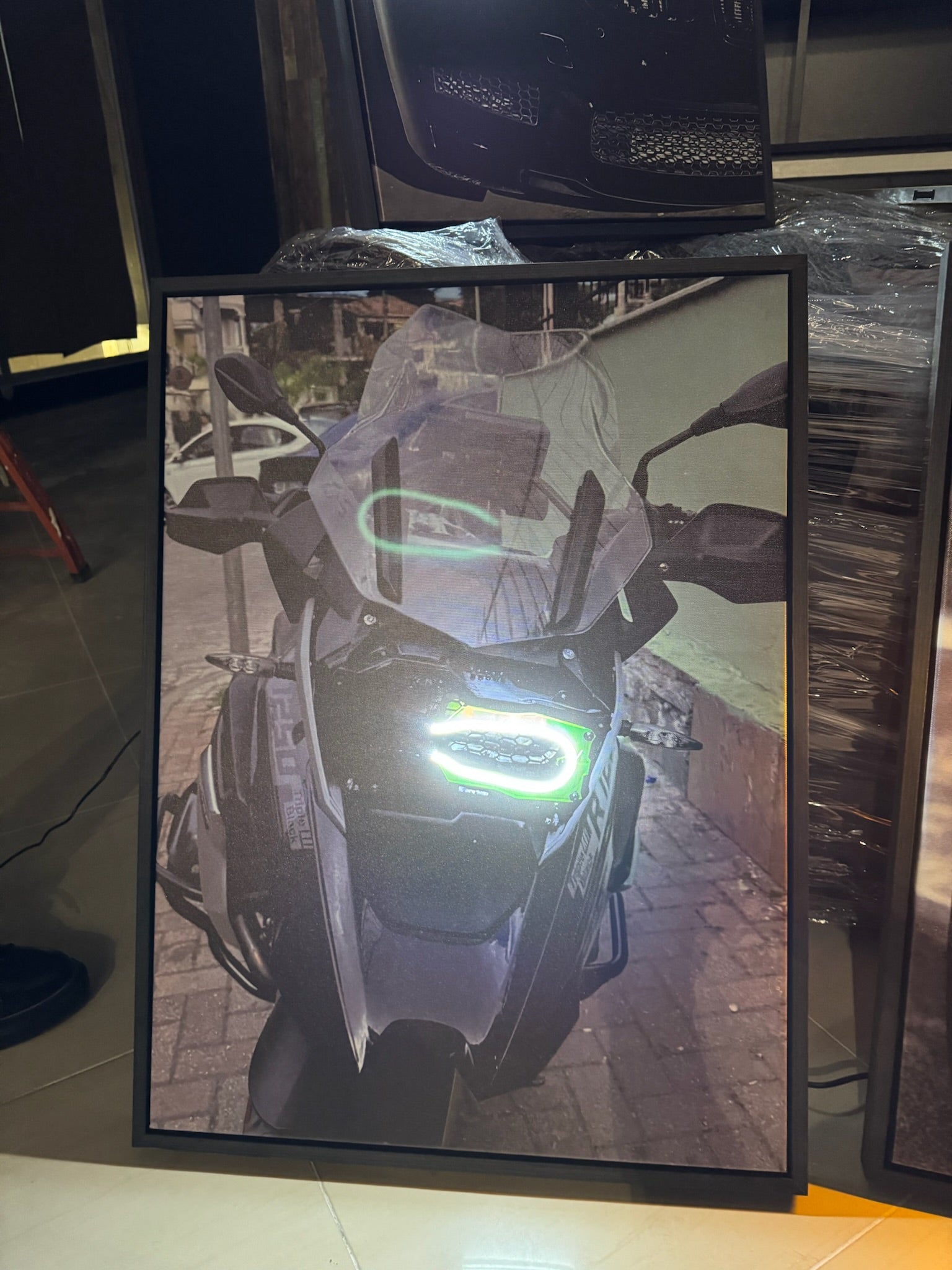 Motorcycle displayed in a showroom with a green light on the screen