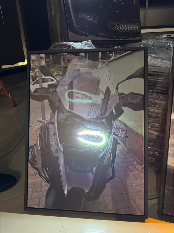 Motorcycle displayed in a showroom with a green light on the screen