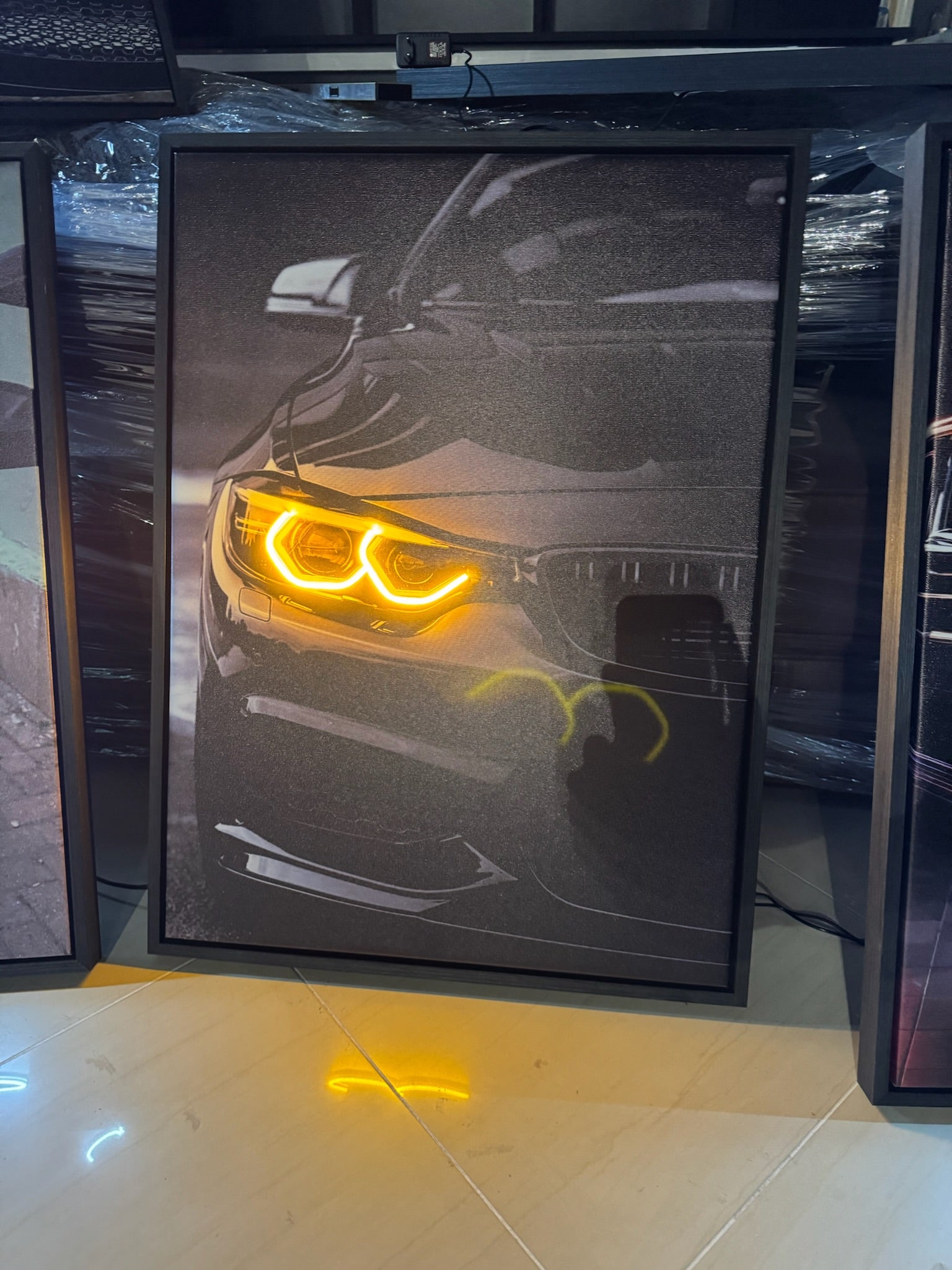 Car headlight with yellow illumination on a reflective surface