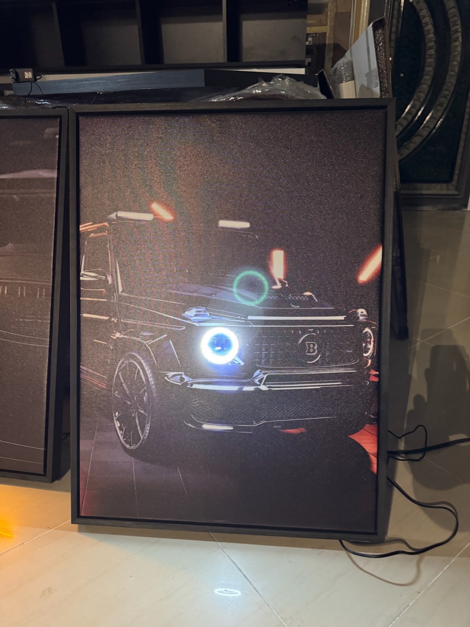 Digital display screen showing a car design on a tiled floor.