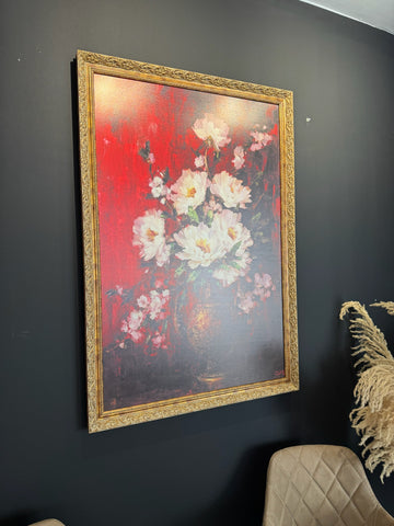 Framed floral painting on a dark wall