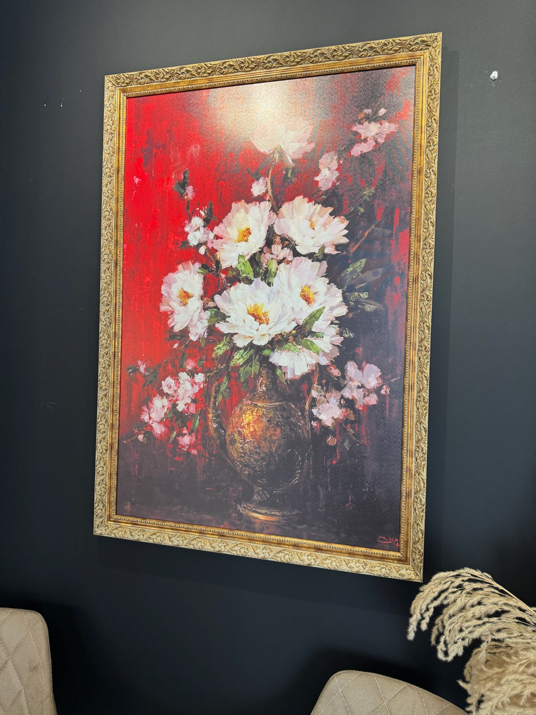 Framed floral painting on a dark wall