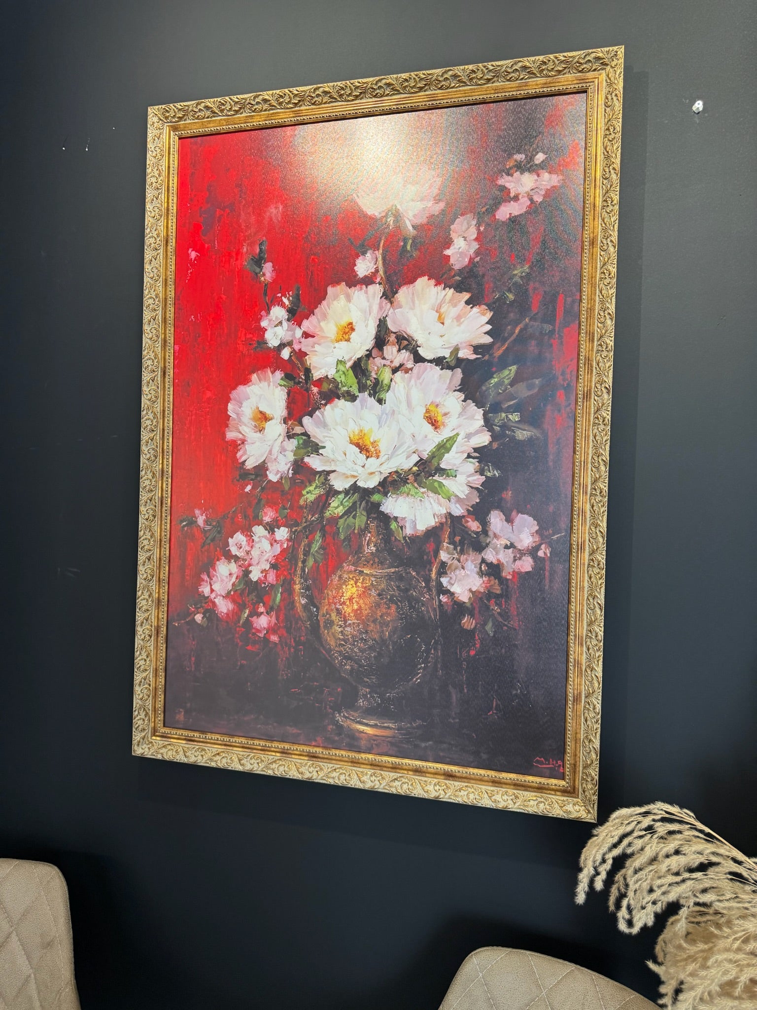 Framed painting of flowers on a dark wall