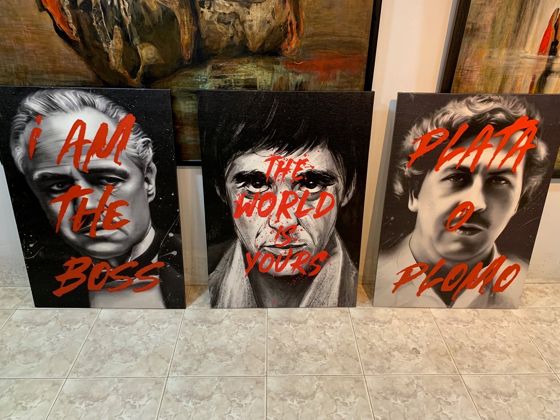 Three artistic portraits with text on a tiled floor.