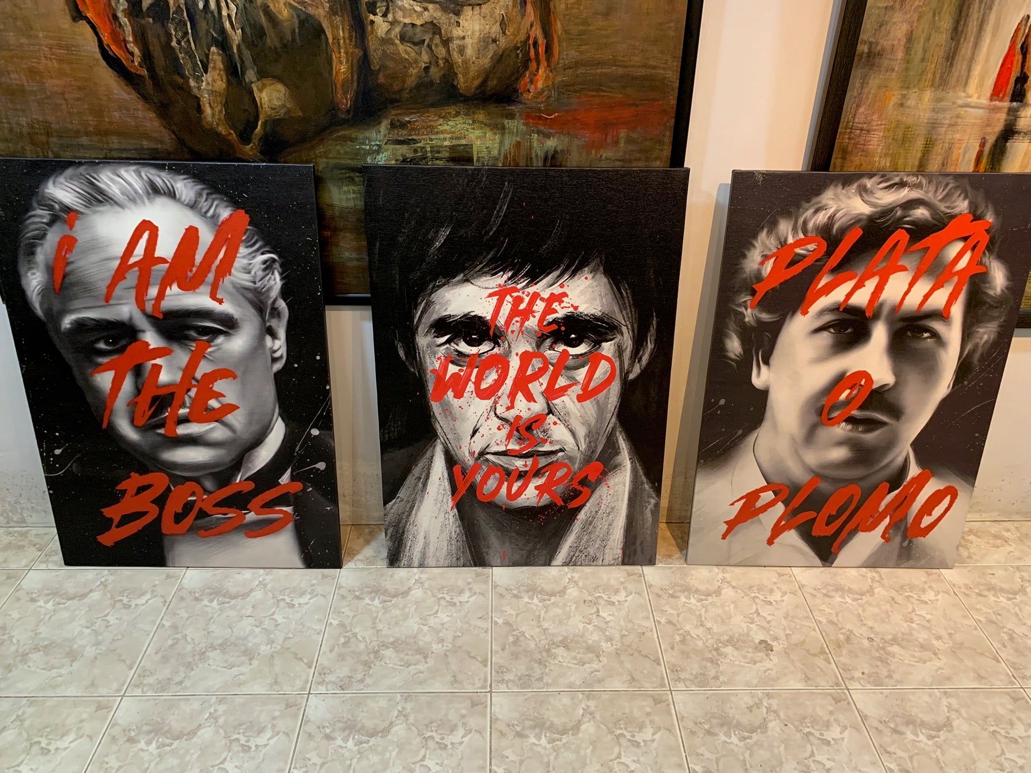Three artistic portraits with text on a tiled floor.