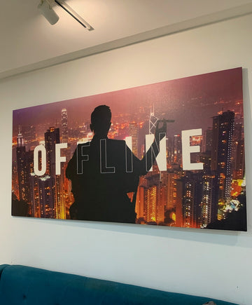 Silhouette of a person against a cityscape with 'OFFLINE' text on a wall.