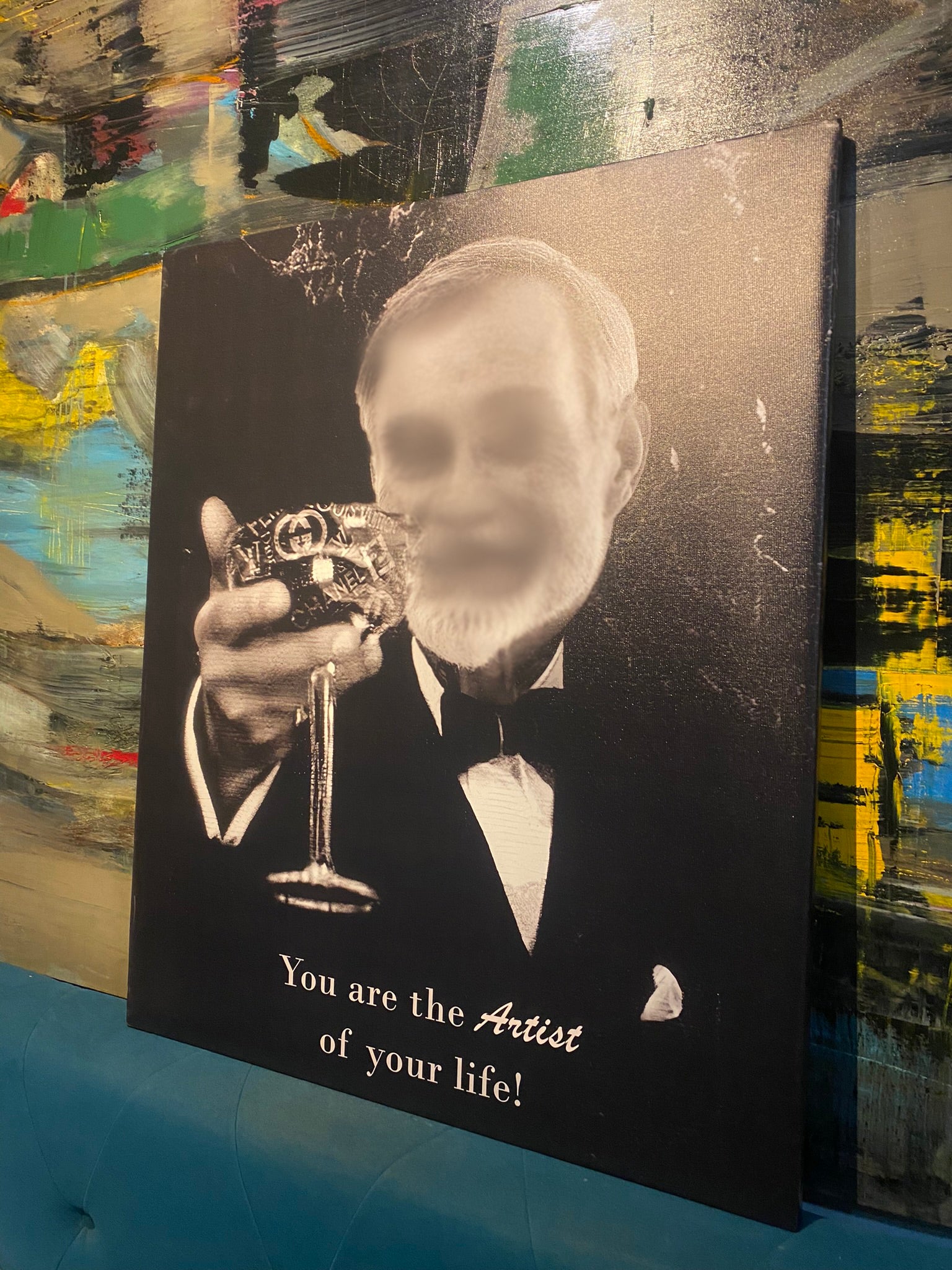 Canvas print with a man in a tuxedo holding a glass, against a colorful abstract background.