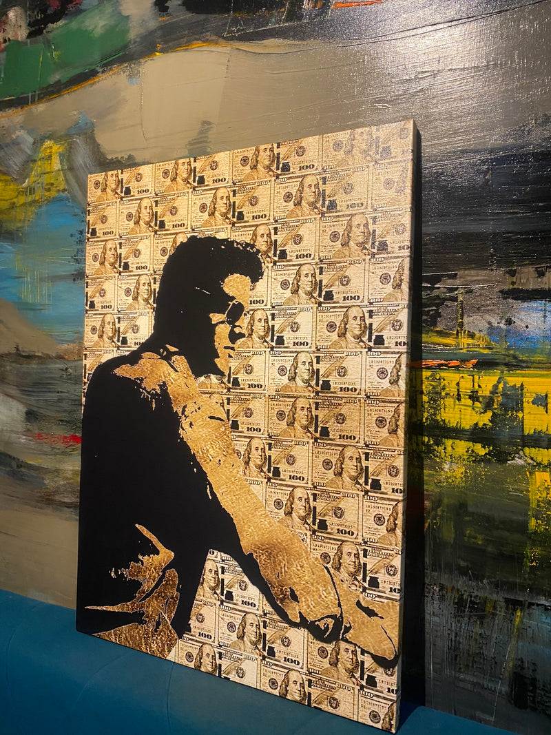 Canvas print with a silhouette of a person and dollar bill pattern on a textured surface.