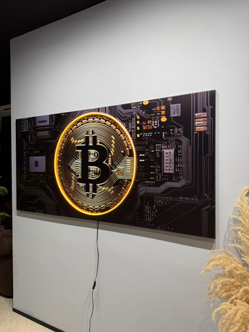 Decorative wall art with Bitcoin symbol on a black background in a modern interior setting.