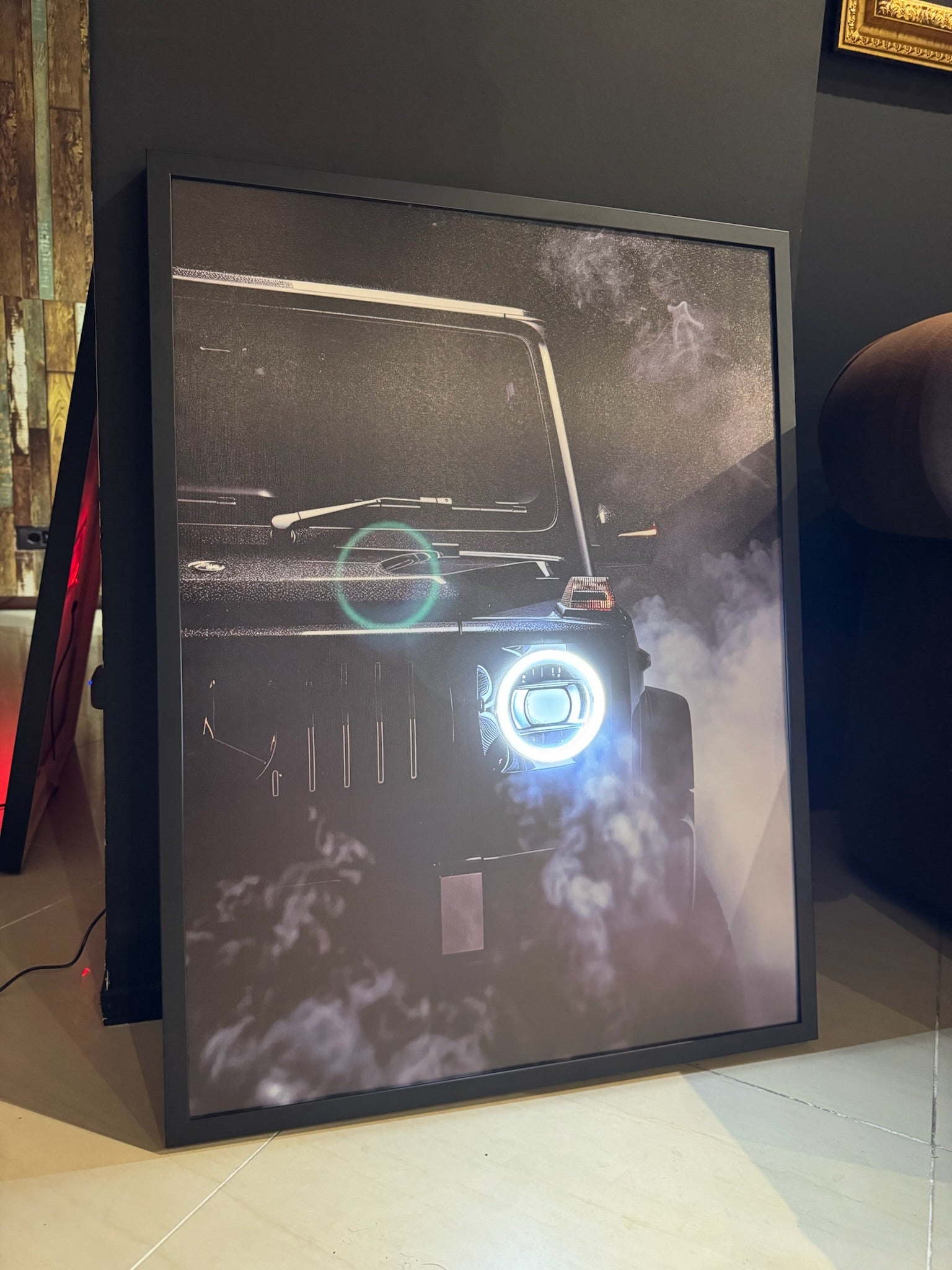 Framed picture of a vehicle on a stand with a blurred background