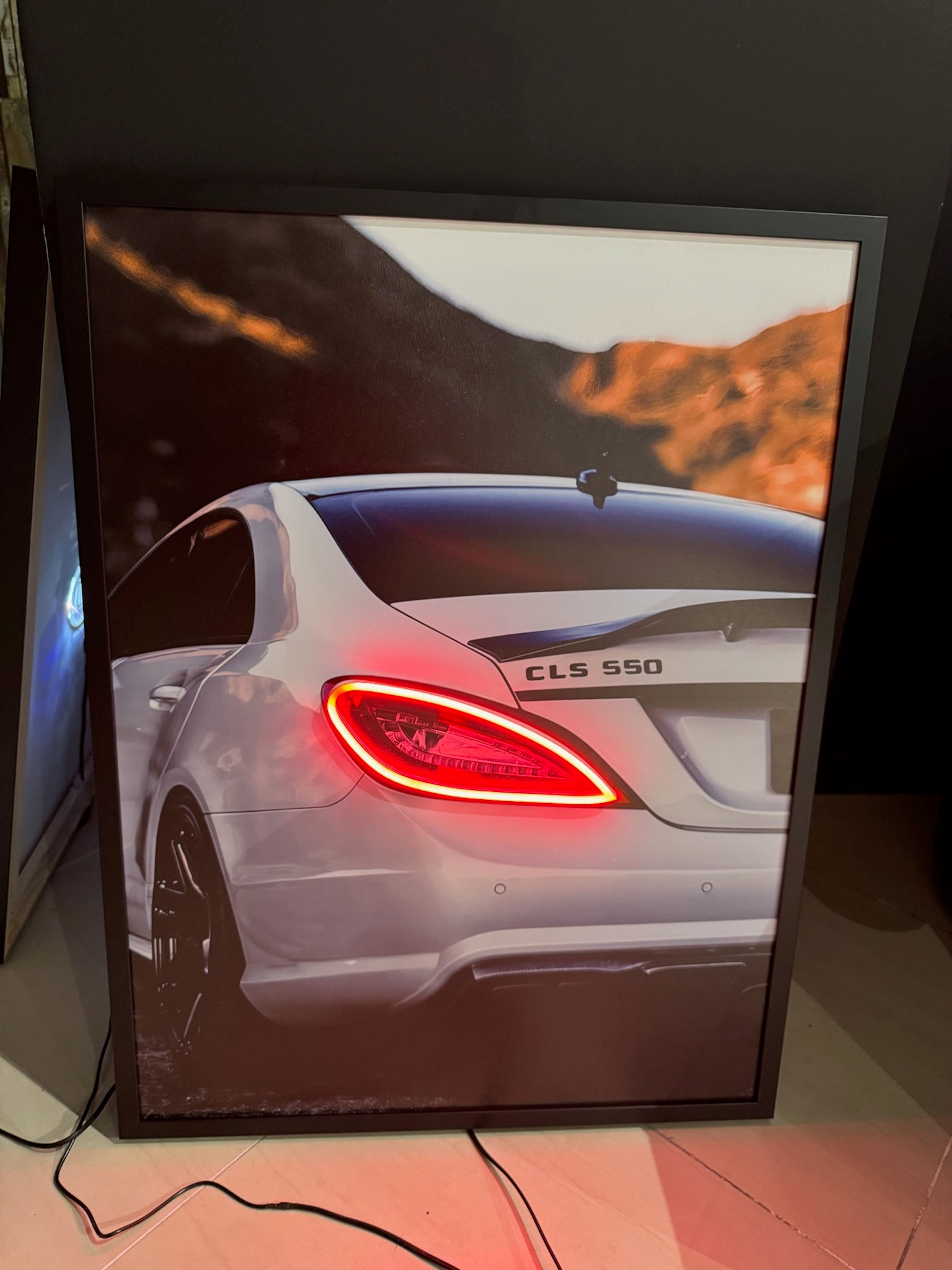 Car model CLS 550 displayed on a screen with a desert landscape background