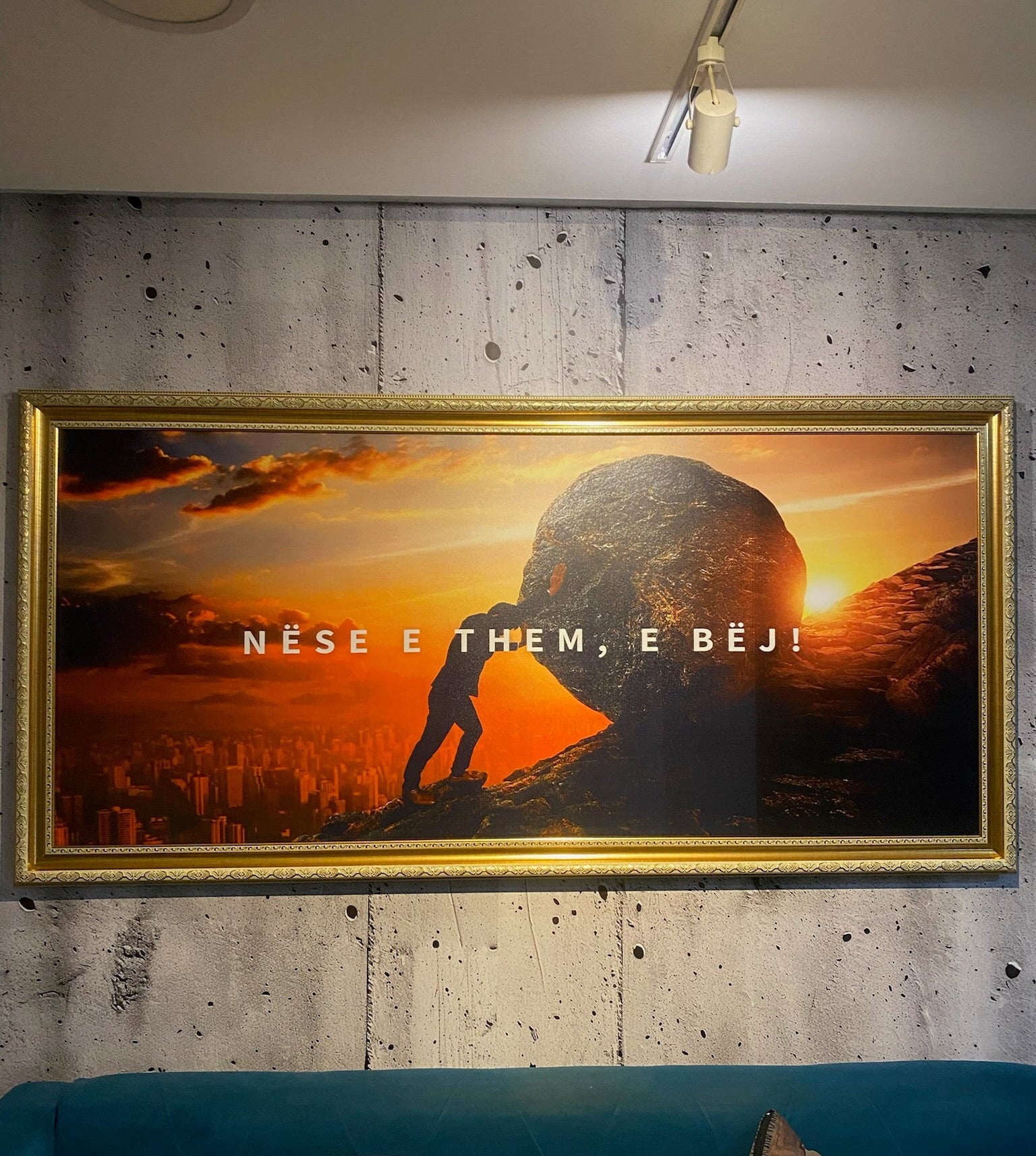 Framed artwork with a silhouette of a person and text on a wall.