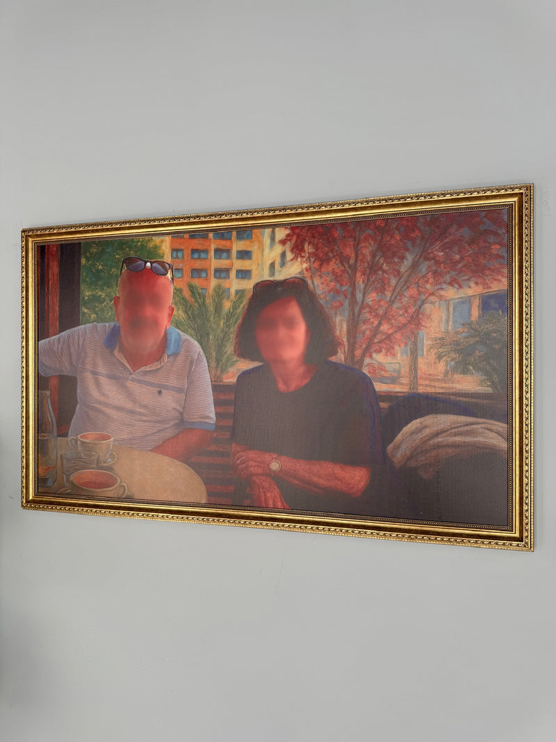 Framed painting of a couple sitting outdoors with a blurred face on a gray wall.