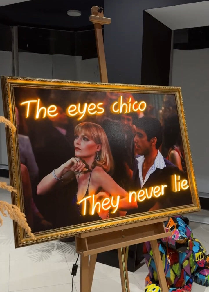 Neon sign with a woman's face and text on an easel