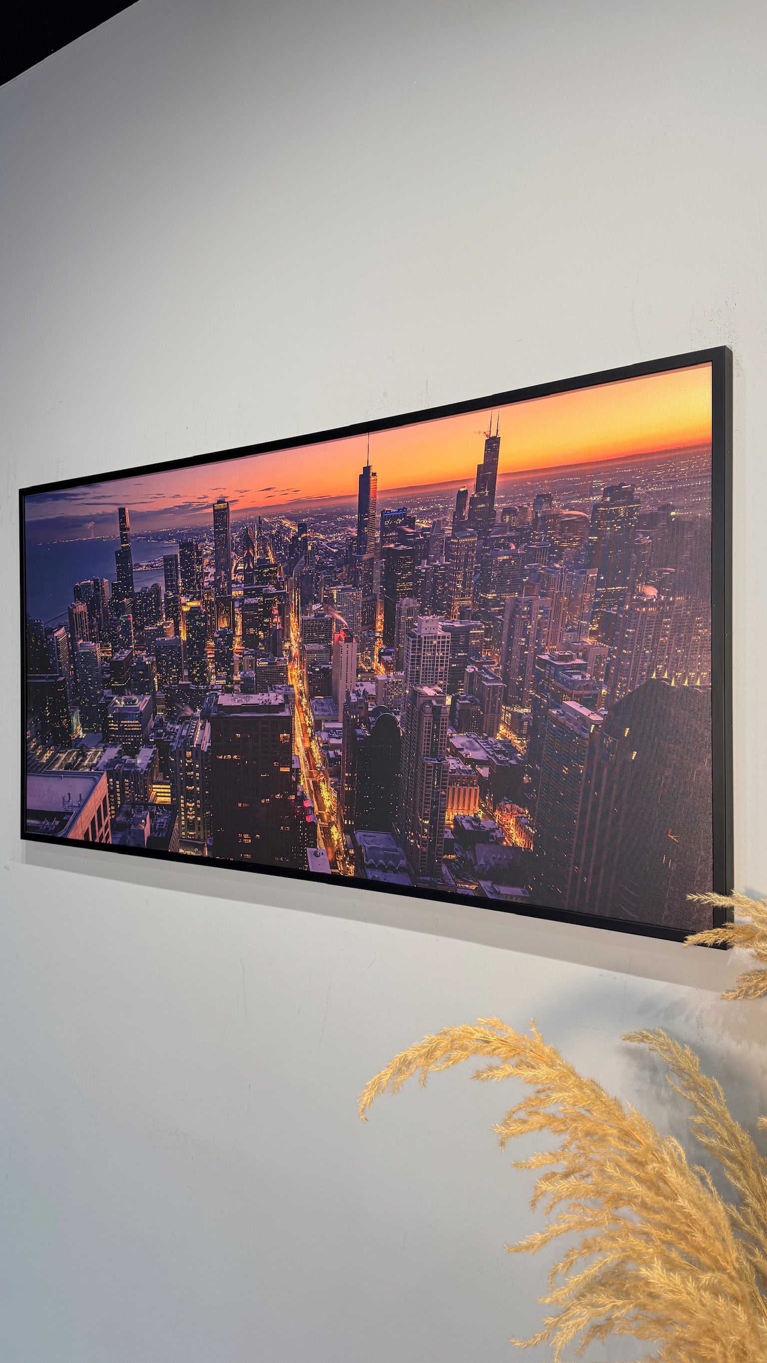 Panorame displaying a cityscape at sunset, mounted on a wall