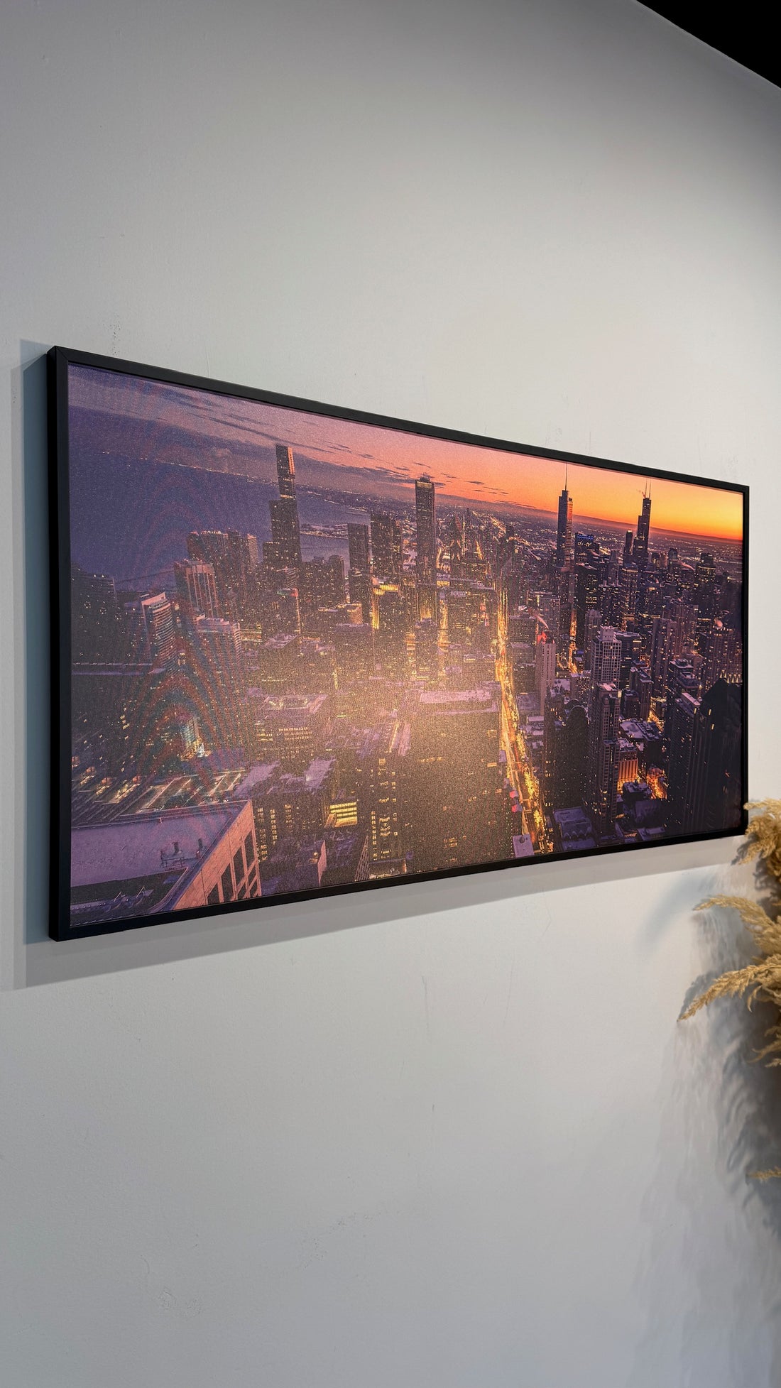 Panorame displaying a cityscape at sunset, mounted on a wall