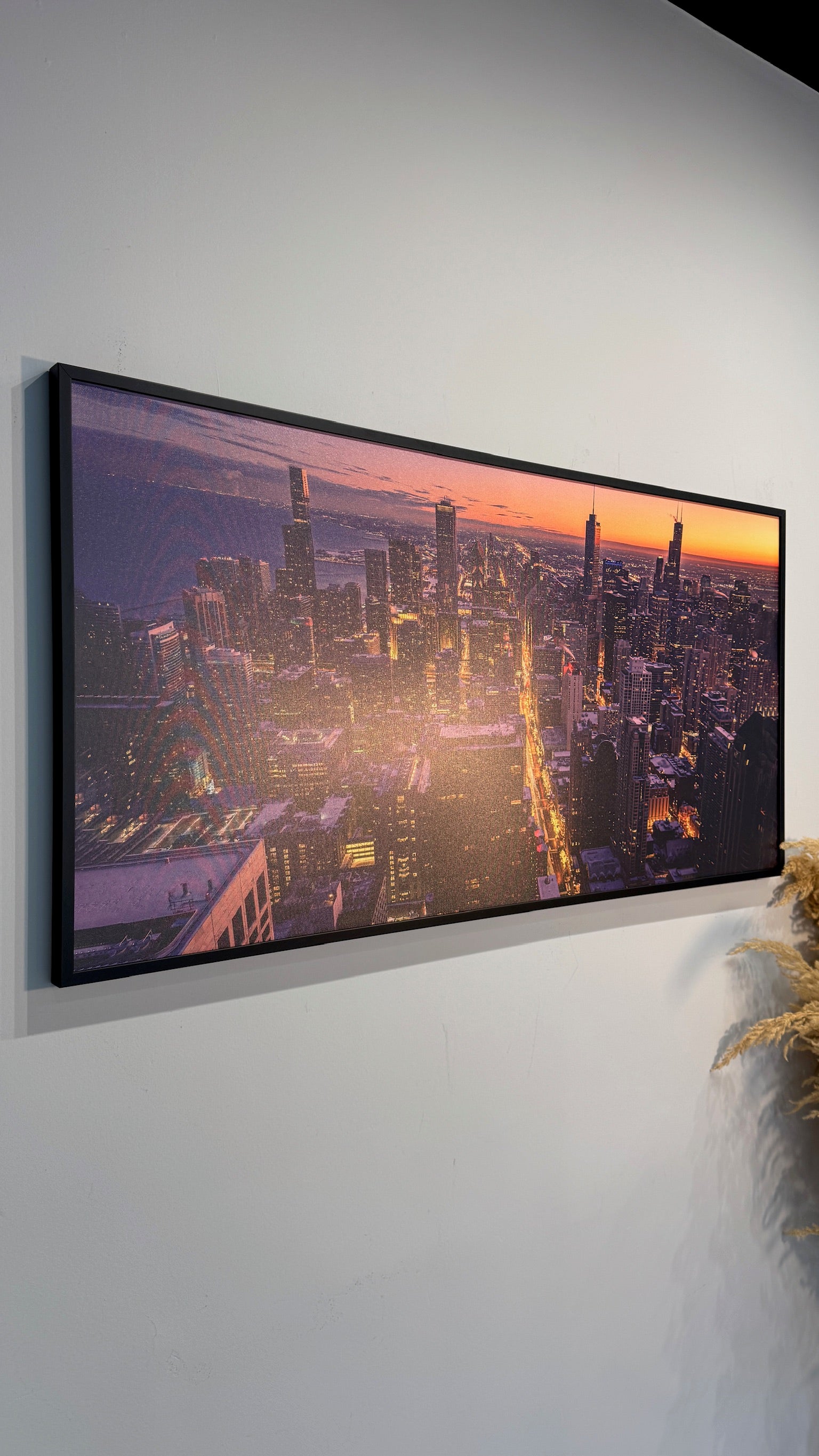 Framed photograph of a cityscape on a white wall