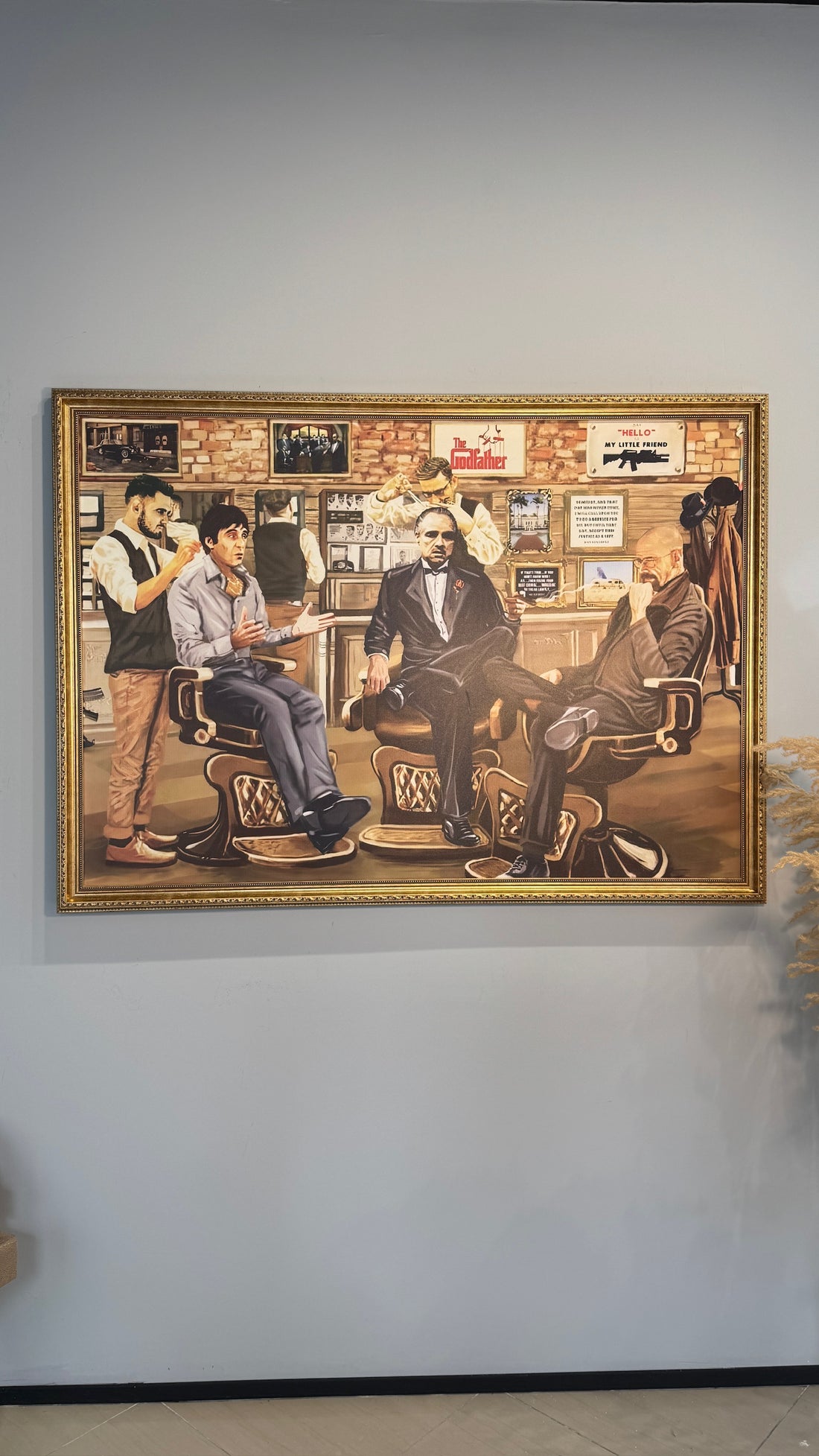 Framed artwork of a barbershop scene with multiple barbers and customers.