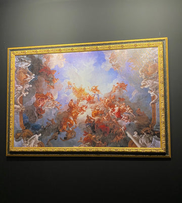 Decorative painting with gold frame on a dark wall