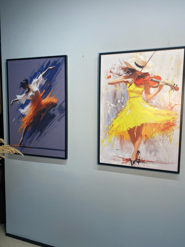 Two framed paintings of dancers on a wall.