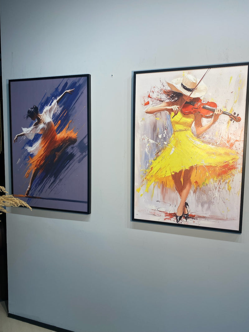 Two framed paintings of dancers on a wall.