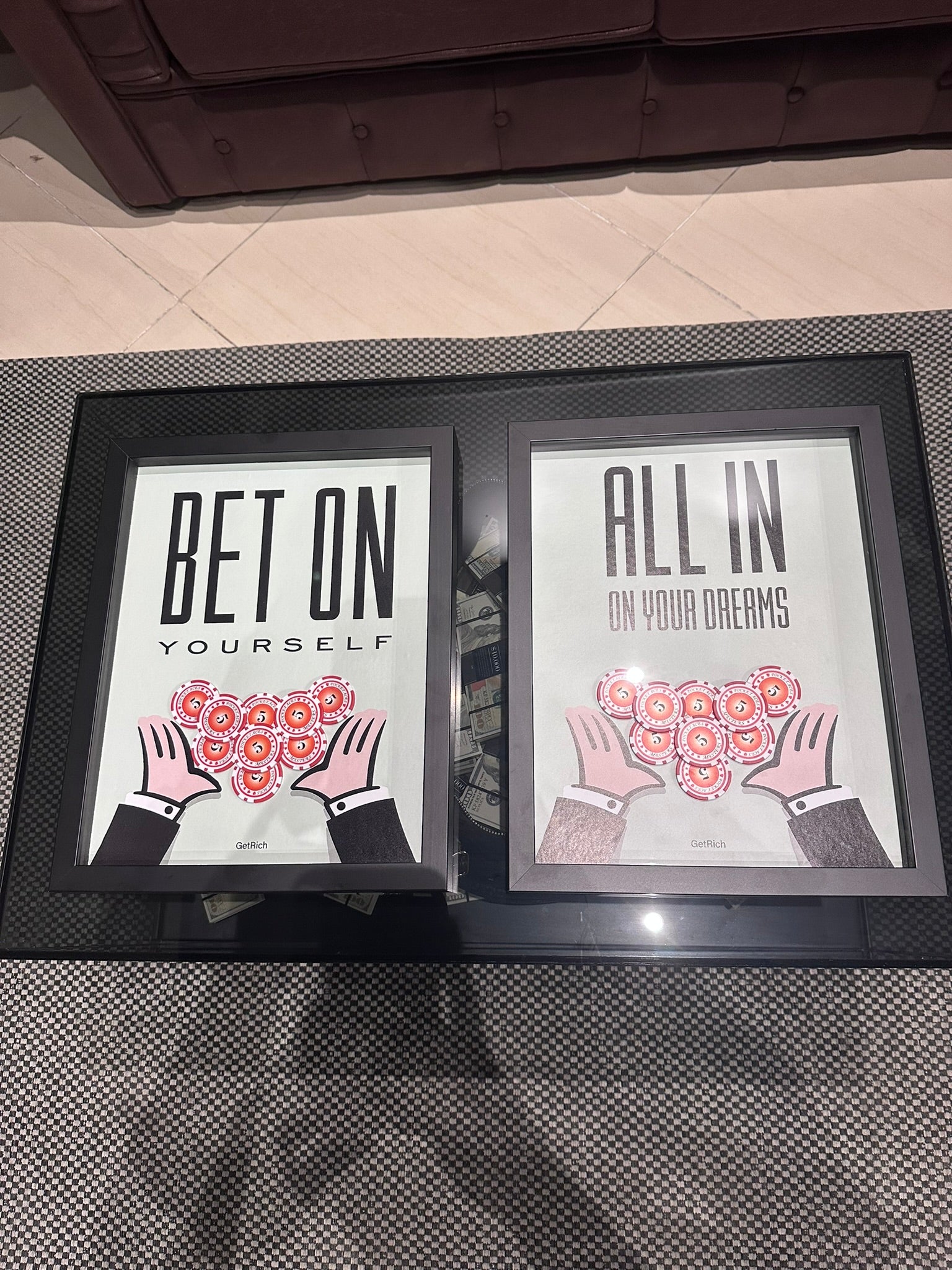 Two framed prints with motivational phrases on a textured surface.