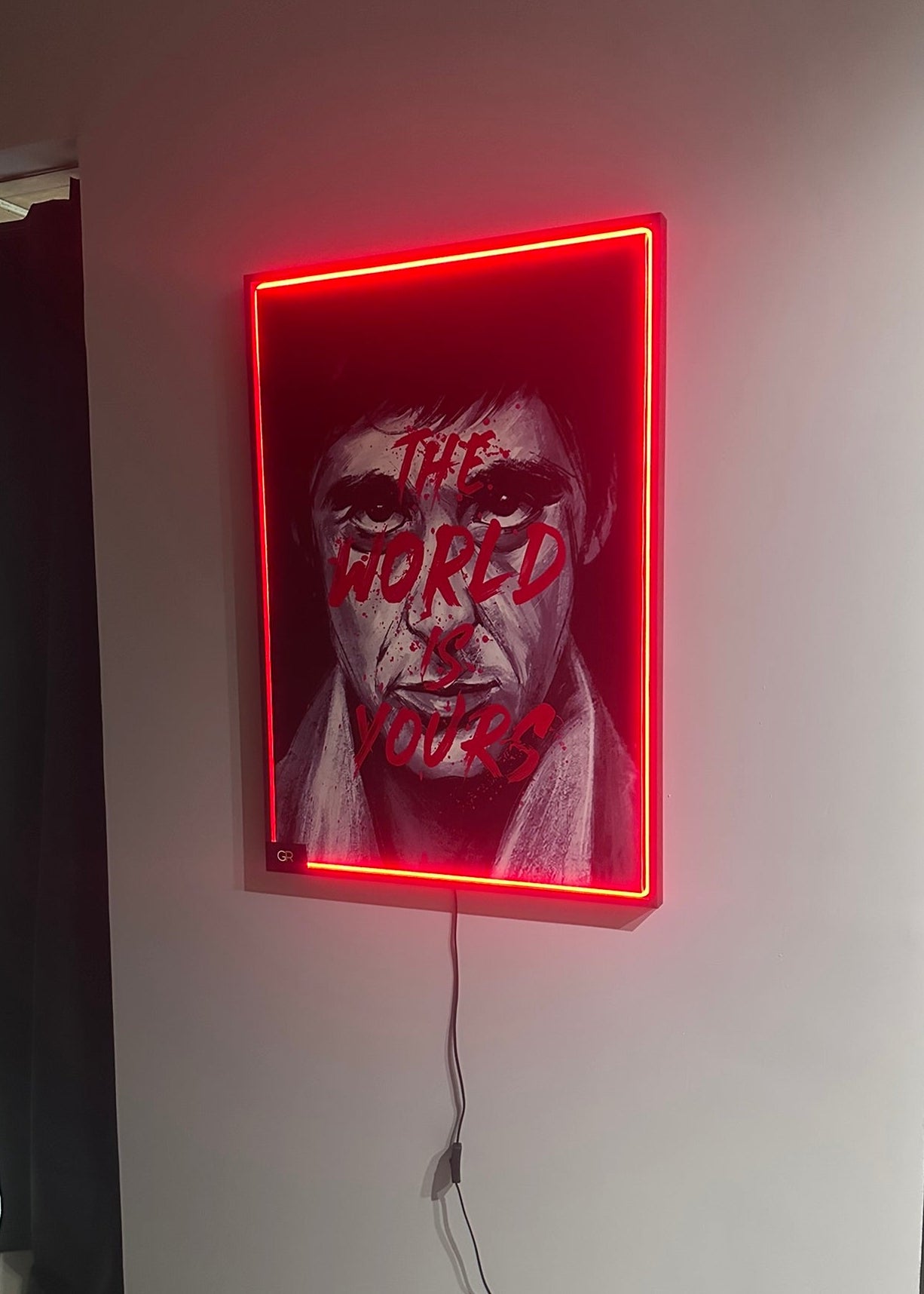 Neon sign with a graphic design on a wall
