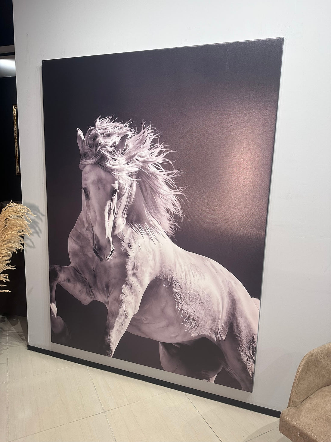 Large wall art of a horse in a room with a plant and chair.