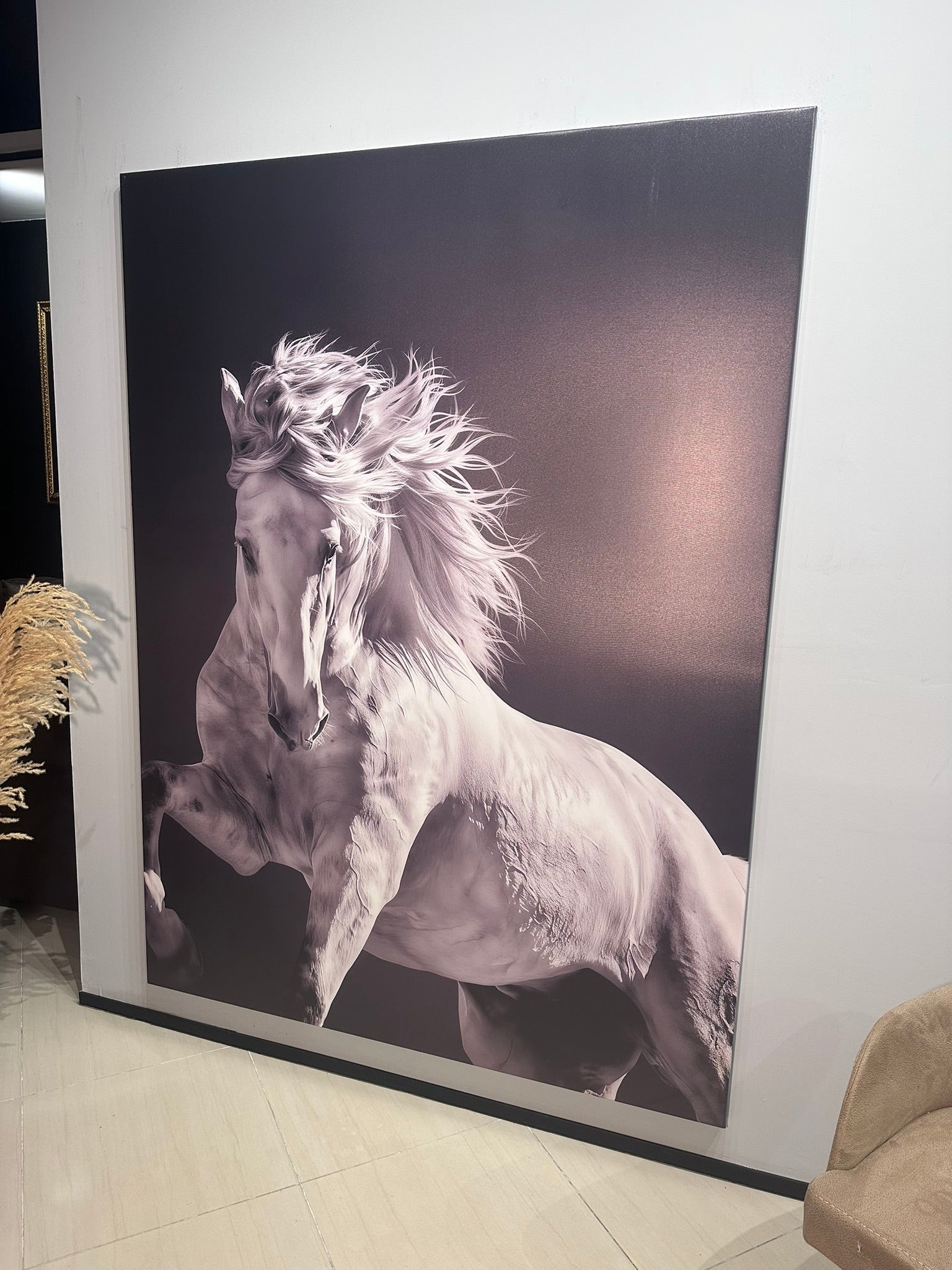 Large wall art of a horse in a room with a plant and chair.