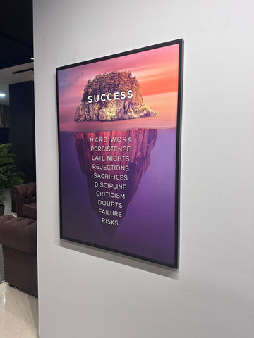 Digital display with motivational quote on a wall in an indoor setting