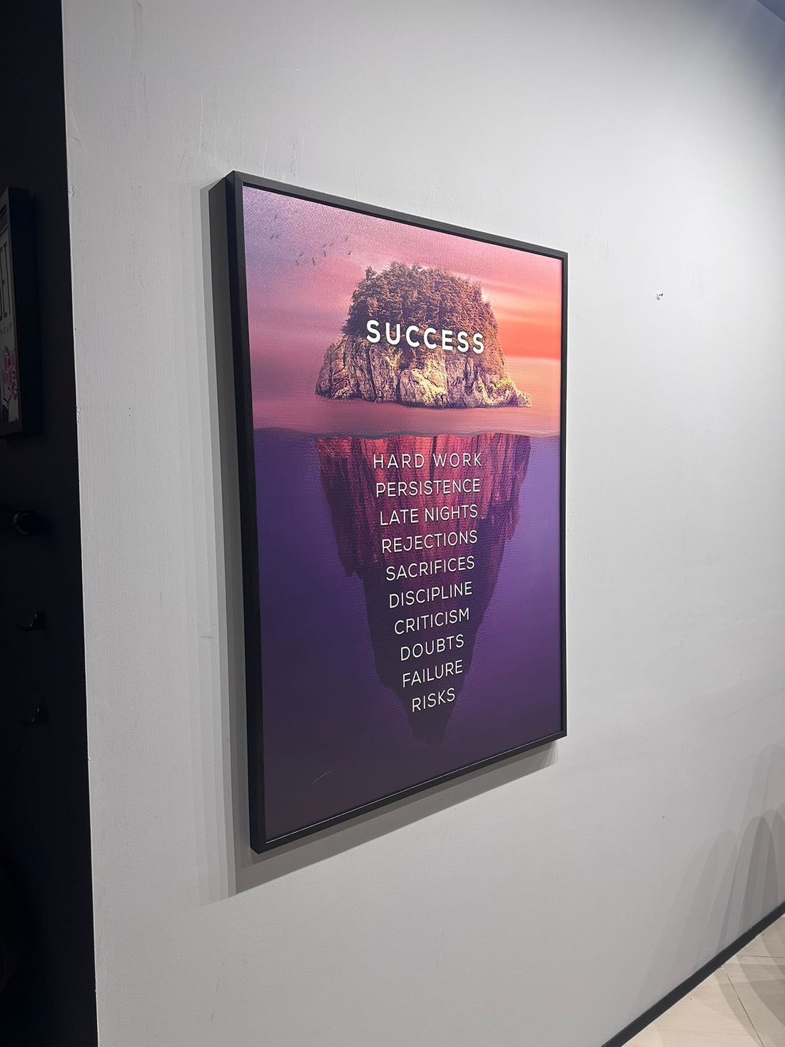Digital display with motivational quote on a wall in an indoor setting