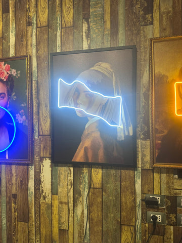 Neon-lit art pieces on a wooden wall