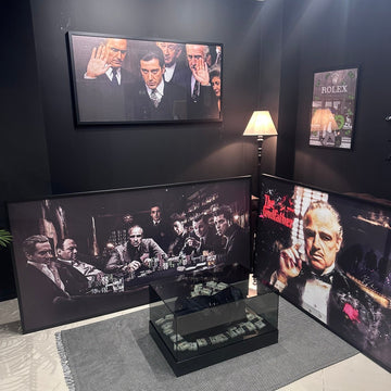 Decorative display with framed pictures of men in formal attire on a wall.