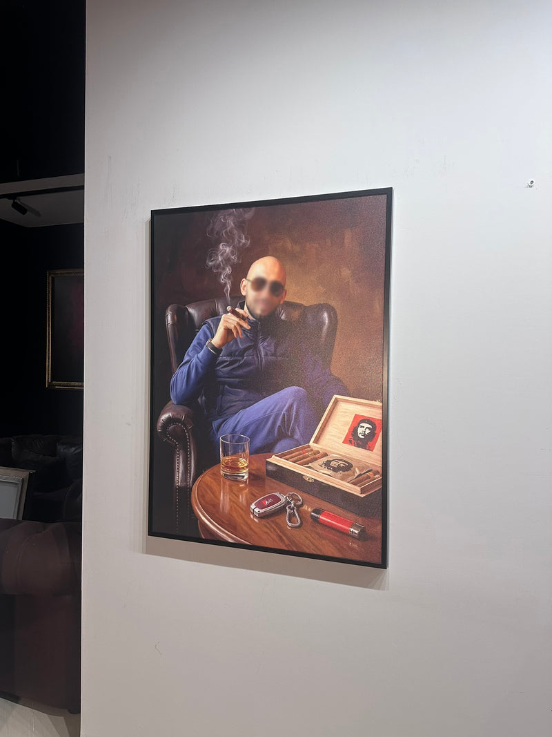 Framed artwork of a man smoking a pipe with a cigar and a glass on a table.