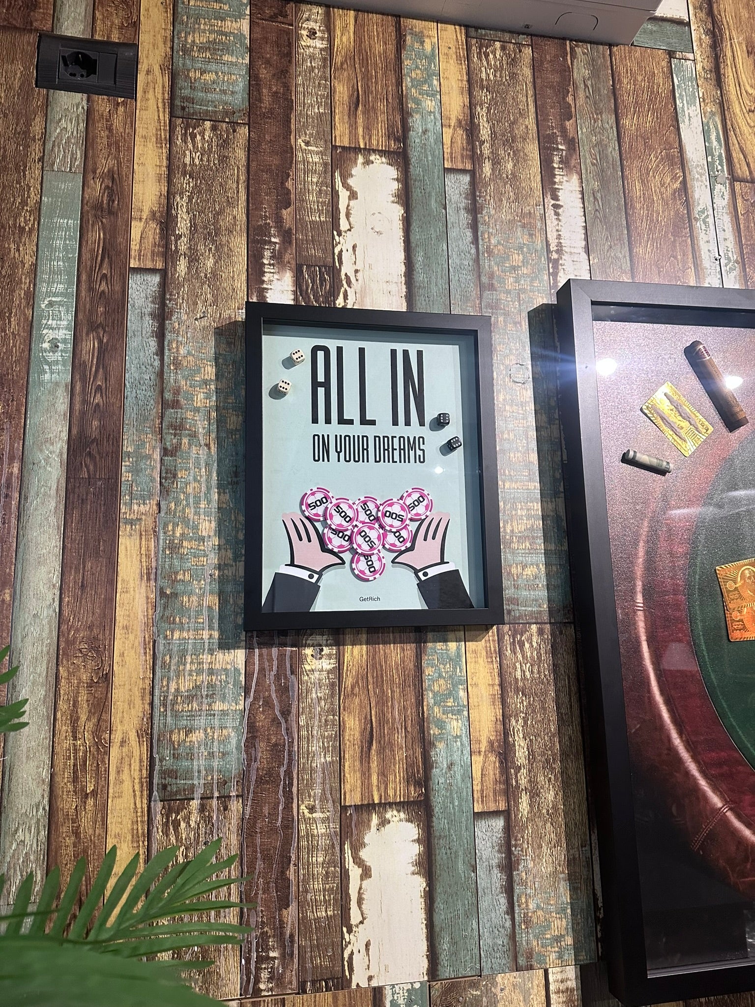 Framed poster with motivational quote on a wooden wall