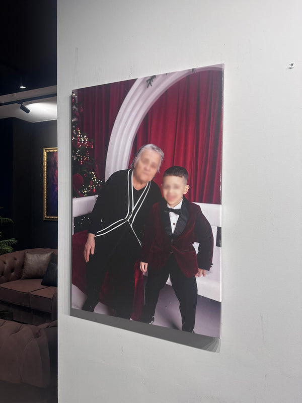 Two people in formal attire standing in a room with red curtains and a Christmas tree.