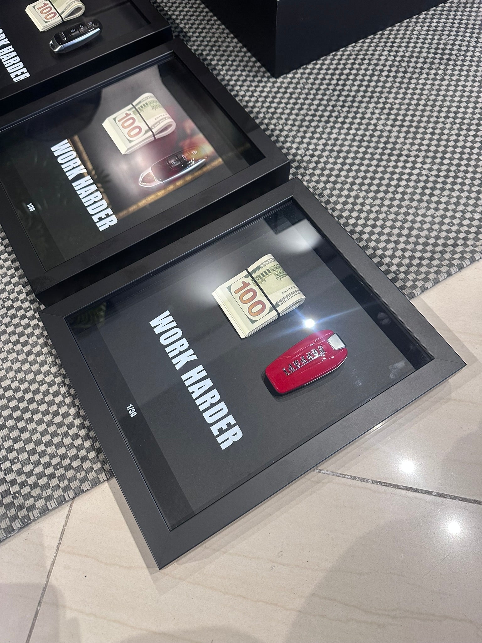 Decorative shadow box with motivational quote 'Work Harder' on a textured surface.