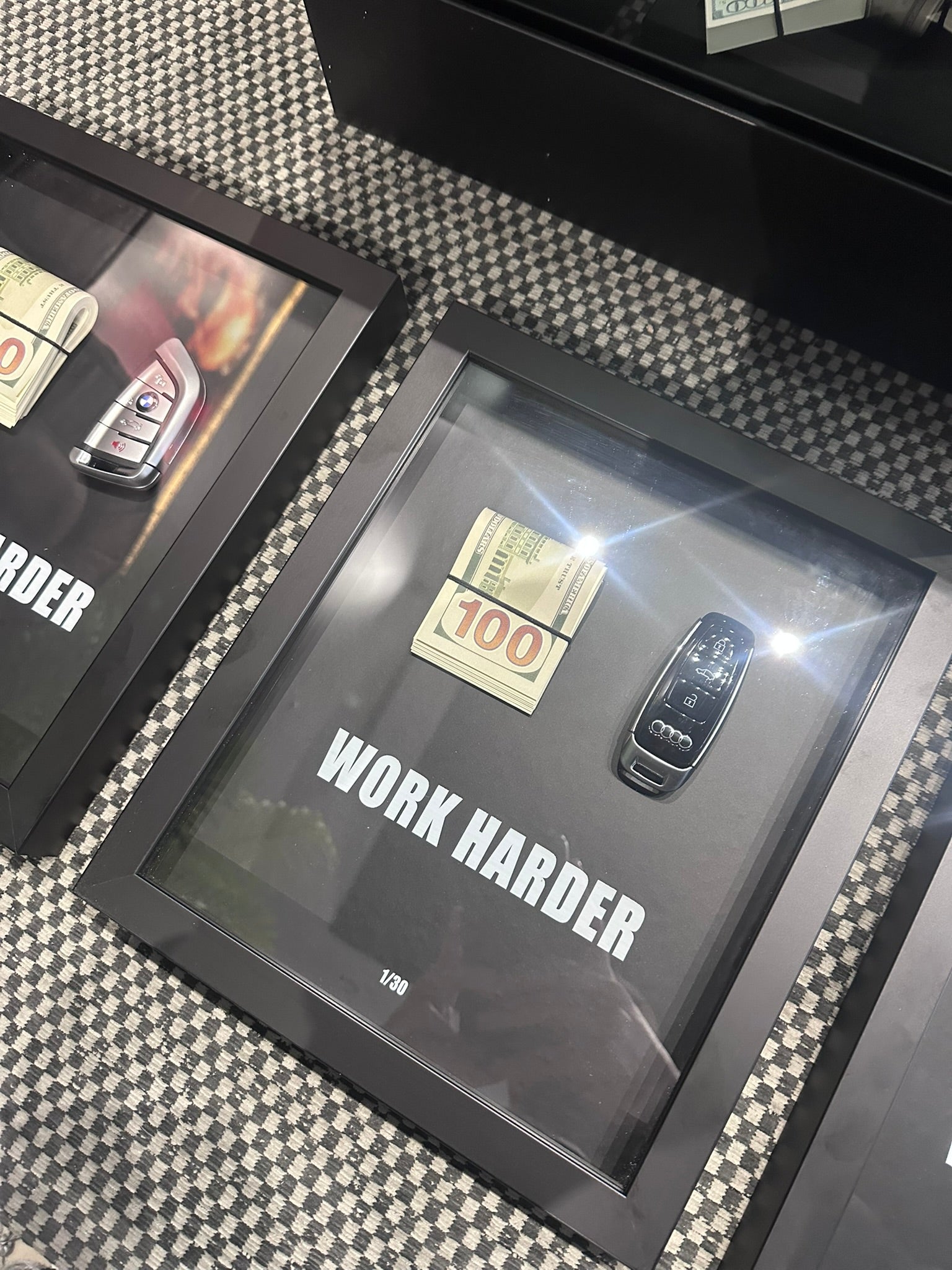 Decorative box with 'Work Harder' quote on a checkered surface