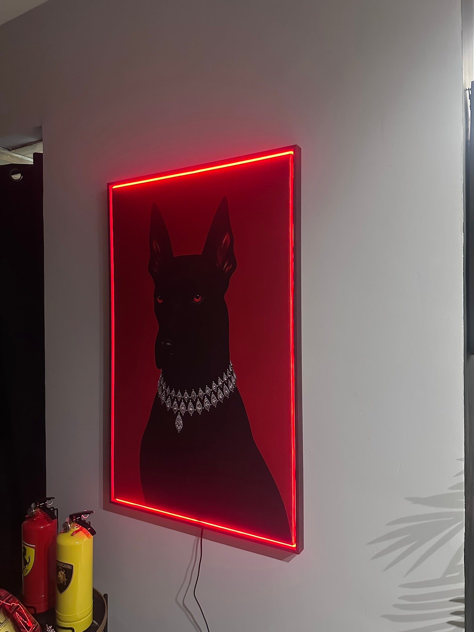 Neon sign of a dog with a red border on a white wall.