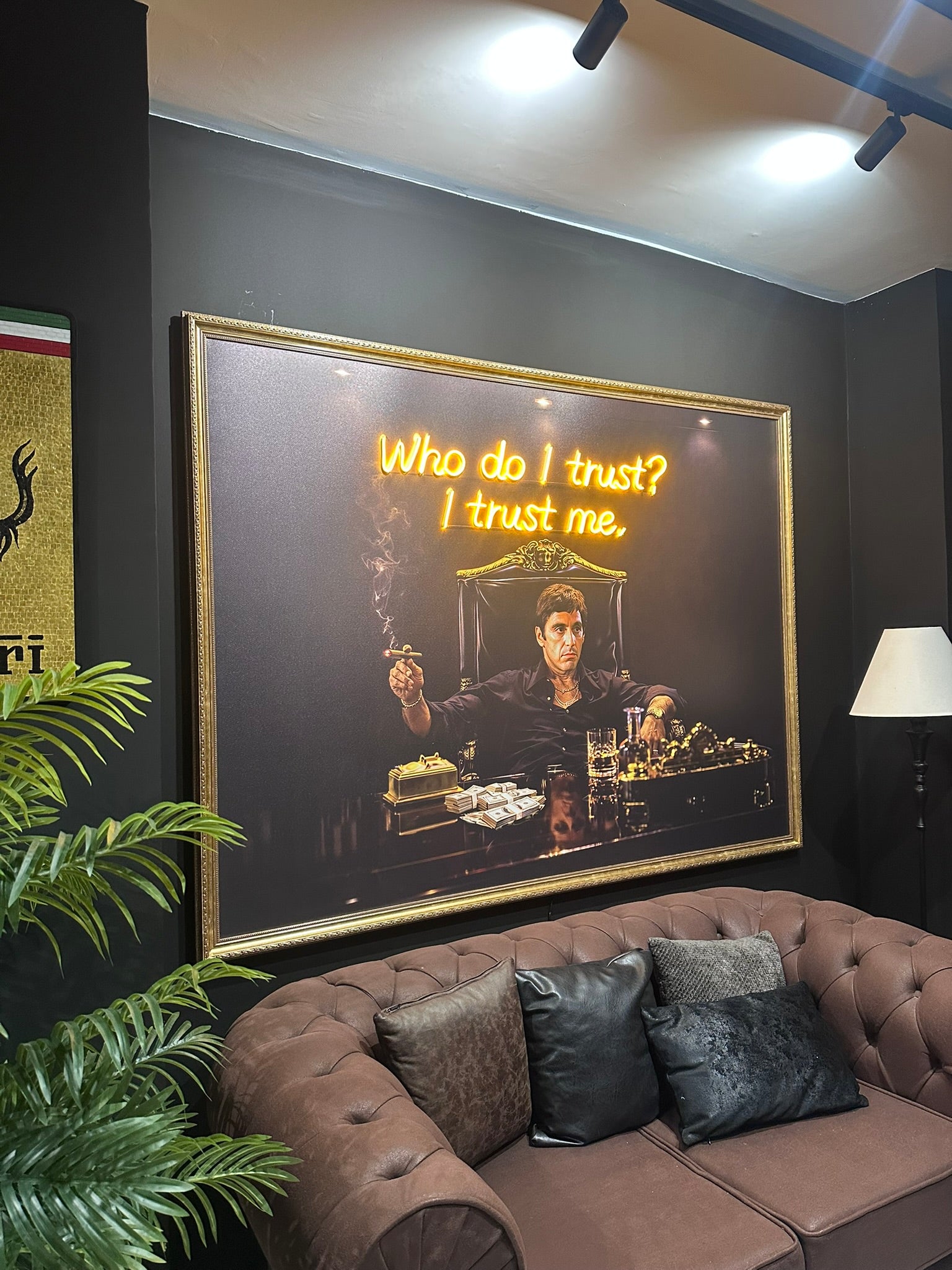 Living room with a large framed picture on the wall and a brown sofa.